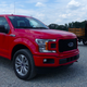A new F-150 next to a Ford Model TT, Ford’s first “purpose-built” pickup, which launched 100 years ago.